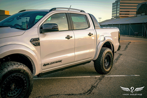 VIKOR electric side step extending on a white Ford Ranger Wildtrak
